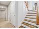 Staircase with carpeted treads, wood railing, and white walls at 108 Faraday Dr, Douglasville, GA 30134