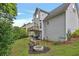 Spacious backyard featuring a deck, fire pit, chairs, a grill, and a lush green lawn at 2018 Township Dr, Woodstock, GA 30189