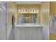 Bright bathroom boasts marble vanity with double sinks, white cabinets, and updated lighting at 2018 Township Dr, Woodstock, GA 30189