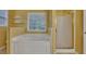 This home's bathroom features a soaking tub, separate shower and a window for natural light at 2018 Township Dr, Woodstock, GA 30189