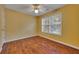 Bright bedroom features a ceiling fan, hardwood floors and a window that lets in natural light at 2018 Township Dr, Woodstock, GA 30189