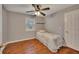 This bedroom features hardwood floors, light grey walls, and a comfortable twin bed at 2018 Township Dr, Woodstock, GA 30189