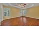 Spacious bedroom features hardwood floors, yellow walls, a ceiling fan and plenty of natural light at 2018 Township Dr, Woodstock, GA 30189