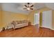 Bonus room features hardwood floors and a plush sofa perfect for relaxing or entertaining at 2018 Township Dr, Woodstock, GA 30189