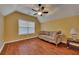 Bonus room features hardwood floors, a window letting in natural light and a comfortable sofa at 2018 Township Dr, Woodstock, GA 30189