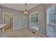 Bright dining area with large windows and modern light fixture at 2018 Township Dr, Woodstock, GA 30189