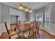 Charming dining room with a wooden table and chairs, decorative lighting, and views to adjacent living area at 2018 Township Dr, Woodstock, GA 30189