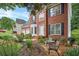 Attractive brick home featuring front yard seating area and a meticulously landscaped garden at 2018 Township Dr, Woodstock, GA 30189
