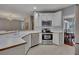 Bright kitchen features white cabinets, stainless steel appliances, and updated countertops at 2018 Township Dr, Woodstock, GA 30189