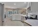 Open kitchen with stainless steel appliances, white cabinets and dining area in background at 2018 Township Dr, Woodstock, GA 30189
