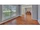 Well-lit living room featuring hardwood flooring, neutral wall colors, and a dining room view at 2018 Township Dr, Woodstock, GA 30189