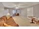 Spacious living area featuring plush carpeting and a ceiling fan for added comfort at 2018 Township Dr, Woodstock, GA 30189