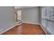 Cozy living room featuring hardwood floors, natural lighting from windows, and neutral color palette at 2018 Township Dr, Woodstock, GA 30189