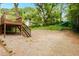 The wooden deck with stairs leads to a gravel backyard with a shed and covered parking at 677 Holmes Nw St, Atlanta, GA 30318