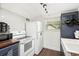 Basement kitchen area features white appliances, subway tile backsplash, and an undermount sink at 677 Holmes Nw St, Atlanta, GA 30318