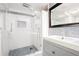 Modern bathroom with a glass-enclosed shower and vanity with a gray cabinet at 677 Holmes Nw St, Atlanta, GA 30318