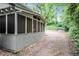Exterior view of screened-in porch addition with a path and wooded area at 677 Holmes Nw St, Atlanta, GA 30318