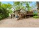 This home features a wooden deck with stairs, nestled in a backyard with trees at 677 Holmes Nw St, Atlanta, GA 30318
