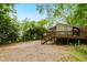 The rear exterior features a deck with wooden railings overlooking the gravel ground at 677 Holmes Nw St, Atlanta, GA 30318