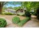 Charming craftsman home featuring a well-manicured front yard with stone pathway and lush landscaping at 677 Holmes Nw St, Atlanta, GA 30318