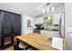 Bright kitchen showcasing white cabinets, stainless steel appliances, and a butcher block island at 677 Holmes Nw St, Atlanta, GA 30318