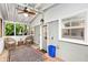 This screened porch features a ceiling fan, windows, and outdoor furniture on a patterned rug at 677 Holmes Nw St, Atlanta, GA 30318