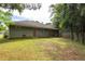 Green backyard featuring a home's exterior, lush lawn, and trees at 6770 Gordon Manor Sw Ct, Mableton, GA 30126