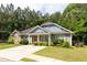 Charming single-story home with stone accents, inviting front porch, and well-manicured lawn at 6770 Gordon Manor Sw Ct, Mableton, GA 30126