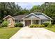 Attractive home with stone and siding exterior, enhanced by lush landscaping and mature trees at 6770 Gordon Manor Sw Ct, Mableton, GA 30126