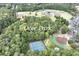 Aerial view of Ocee Park's baseball fields, tennis courts, and parking surrounded by lush trees at 10735 Pinewalk Forest Cir, Alpharetta, GA 30022