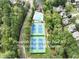Aerial view of Pinewalk community pool with tennis and pickleball courts surrounded by beautiful trees at 10735 Pinewalk Forest Cir, Alpharetta, GA 30022