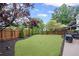 Beautifully landscaped backyard with lush green grass and a privacy fence at 10735 Pinewalk Forest Cir, Alpharetta, GA 30022