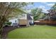 Large, well-maintained backyard with a patio area and mature trees at 10735 Pinewalk Forest Cir, Alpharetta, GA 30022