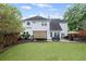 Spacious backyard featuring a patio, hot tub, and manicured lawn at 10735 Pinewalk Forest Cir, Alpharetta, GA 30022