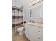 Bathroom showcasing a white vanity with a modern sink and a shower with a striped curtain at 10735 Pinewalk Forest Cir, Alpharetta, GA 30022