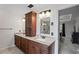 Bathroom with double vanity, granite countertops, and a walk-in tiled shower, and adjacent main bedroom at 10735 Pinewalk Forest Cir, Alpharetta, GA 30022
