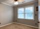 Bedroom with neutral walls, window with blinds, base trim and electrical outlets at 10735 Pinewalk Forest Cir, Alpharetta, GA 30022