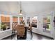 Bright dining area with hardwood floors, large windows, and views of the backyard at 10735 Pinewalk Forest Cir, Alpharetta, GA 30022