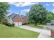 Beautiful two-story brick home with attached garage and a neatly landscaped front yard at 10735 Pinewalk Forest Cir, Alpharetta, GA 30022