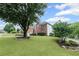 Well-maintained brick home with a lush lawn and mature trees in a suburban setting at 10735 Pinewalk Forest Cir, Alpharetta, GA 30022