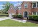 Charming brick home with a two-car garage, landscaped shrubs, and a welcoming front entrance at 10735 Pinewalk Forest Cir, Alpharetta, GA 30022