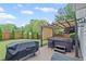 Backyard hot tub with a pergola and manicured landscaping at 10735 Pinewalk Forest Cir, Alpharetta, GA 30022