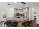 Open kitchen features granite island with seating, stainless steel appliances, and access to the backyard at 10735 Pinewalk Forest Cir, Alpharetta, GA 30022