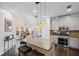 Modern kitchen featuring granite countertops, stainless steel appliances, an island with seating, and ample cabinet space at 10735 Pinewalk Forest Cir, Alpharetta, GA 30022