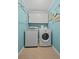 Well-lit laundry room with a washing machine, dryer, storage cabinets, and decorative touches at 10735 Pinewalk Forest Cir, Alpharetta, GA 30022