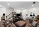Spacious living room with comfortable seating, dark hardwood floors, and an open layout at 10735 Pinewalk Forest Cir, Alpharetta, GA 30022