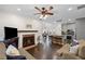 Spacious living area featuring a cozy fireplace, an open floor plan, and hardwood flooring at 10735 Pinewalk Forest Cir, Alpharetta, GA 30022