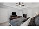 Comfortable main bedroom with a tray ceiling, plush bedding, and dark wood furnishings at 10735 Pinewalk Forest Cir, Alpharetta, GA 30022