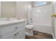 Modern bathroom featuring a vanity with cabinet, a toilet, and a bathtub-shower combination with white walls at 1501 Buckingham, Stockbridge, GA 30281