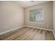 Cozy bedroom with new flooring and a window offering natural light at 1501 Buckingham, Stockbridge, GA 30281